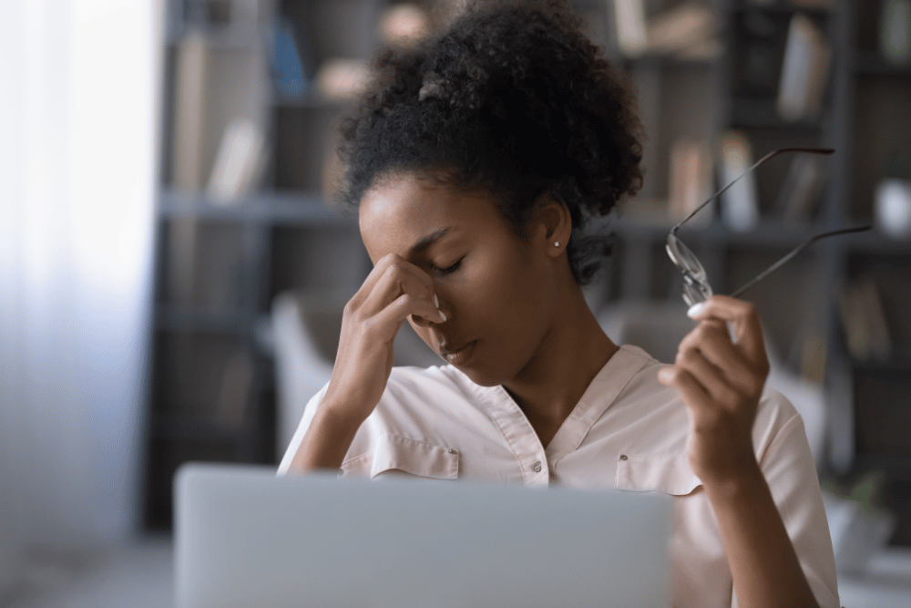 woman holding her hand to her face due to discomfort