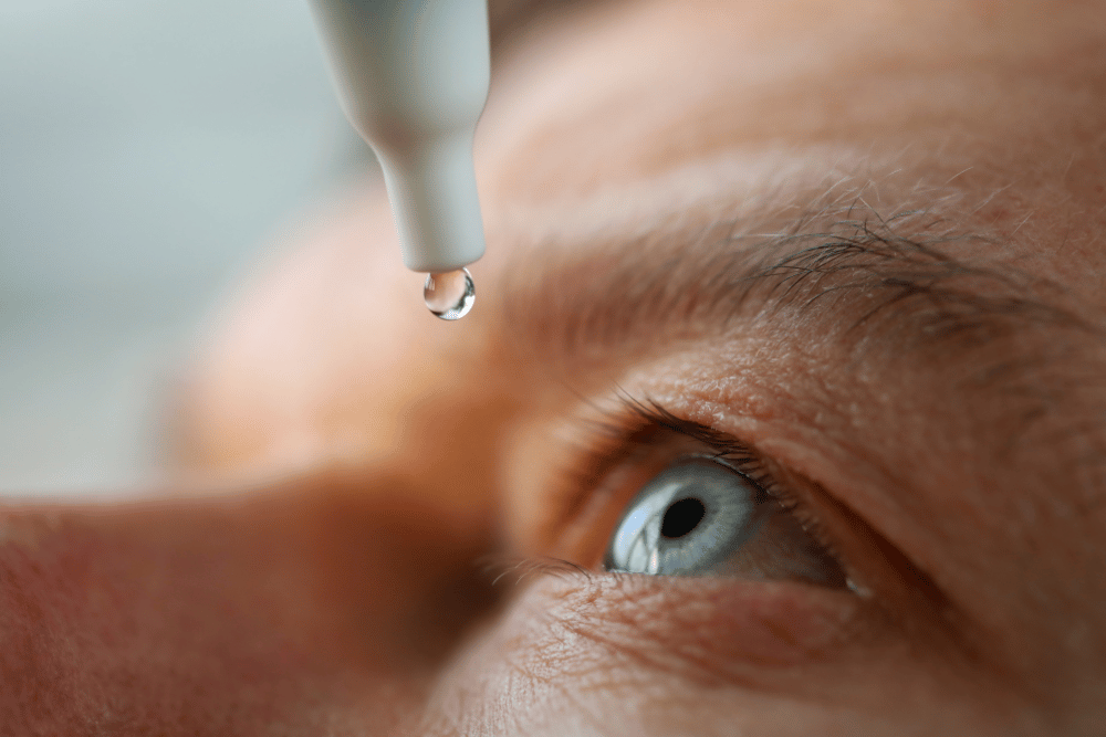 close-up of a man putting in eye drops