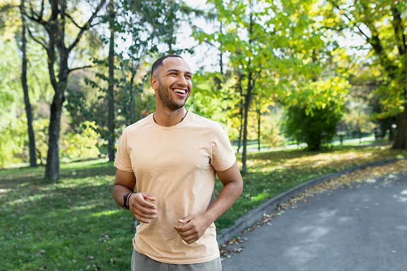 a man standing outside in a park